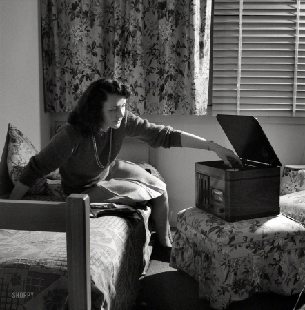 Photo showing: Record Time -- June 1943. Arlington, Virginia. Girl in her room playing phonograph at Arlington Farms,
a residence for women who work in the government for the duration of the war.