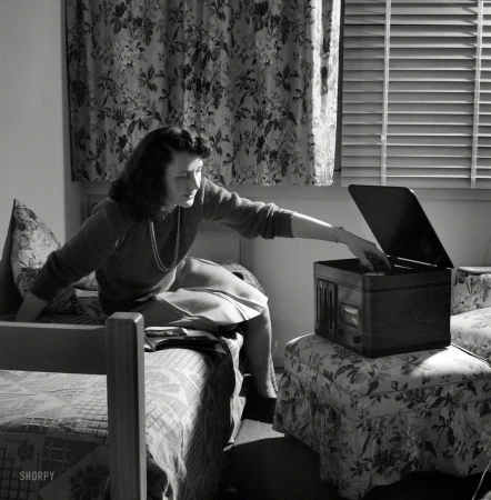 Photo showing: Record Time -- June 1943. Arlington, Virginia. Girl in her room playing phonograph at Arlington Farms,
a residence for women who work in the government for the duration of the war.