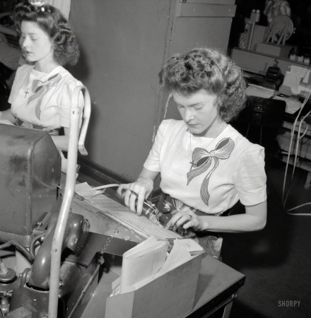 Photo showing: Doris and Dot -- June 1943. Washington, D.C. Pasting up a telegram at the Western Union telegraph
office. Doris and Dorothy Bell send and receive telegrams from the Baltimore circuit. 
