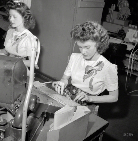 Photo showing: Doris and Dot -- June 1943. Washington, D.C. Pasting up a telegram at the Western Union telegraph
office. Doris and Dorothy Bell send and receive telegrams from the Baltimore circuit. 