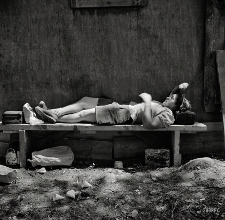 Photo showing: Ruth at Rest -- June 1943. Turkey Pond, near Concord, New Hampshire. Ruth De Roche,
18-year-old sawmill 'pit woman,' resting during the lunch hour.