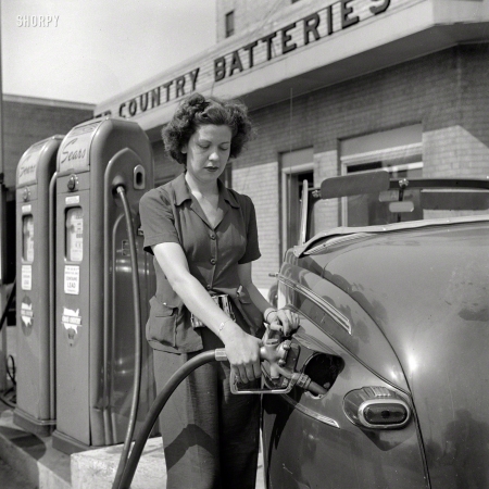 Photo showing: Fill It With Ethyl -- June 1943. Louisville, Kentucky. Virginia Lively used to be a beauty operator. Today she works at a gas station.