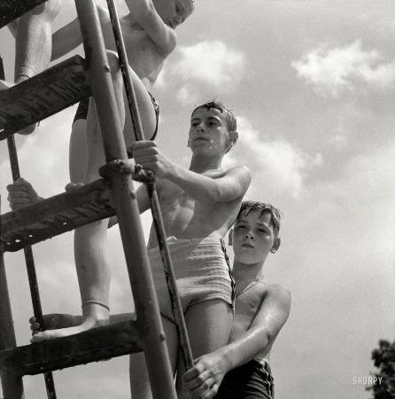 Photo showing: Sliders -- July 1943. Glen Echo, Maryland. Climbing the ladder to the sliding board at the Glen Echo swimming pool. 