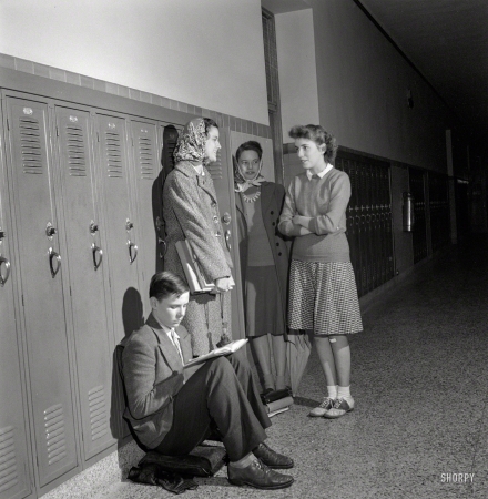 Photo showing: The In Crowd -- October 1943. Washington, D.C. Sally Dessez talking with some friends near her locker at Woodrow Wilson High School.