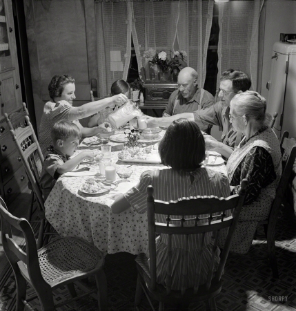 Photo showing: A Place at the Table. -- July 1942. East Montpelier, Vermont. The Charles Ormsbee family at dinner.