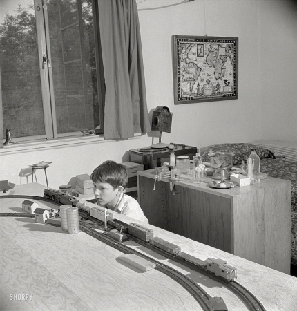 Photo showing: American Boy -- June 1942. Greenbelt, Maryland. Bedroom in which a 13-year-old boy has rigged up model trains and a chemical laboratory.
