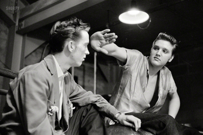 Photo showing: Backstage With Elvis -- May 27, 1956. Dayton, Ohio. A 21-year-old Elvis Presley with cousin Gene Smith backstage at the University of Dayton field house.