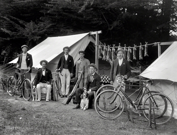 Photo showing: Wabbit Season -- Circa 1910. Rabbit-hunting party of six men, with bicycles, guns and dogs.