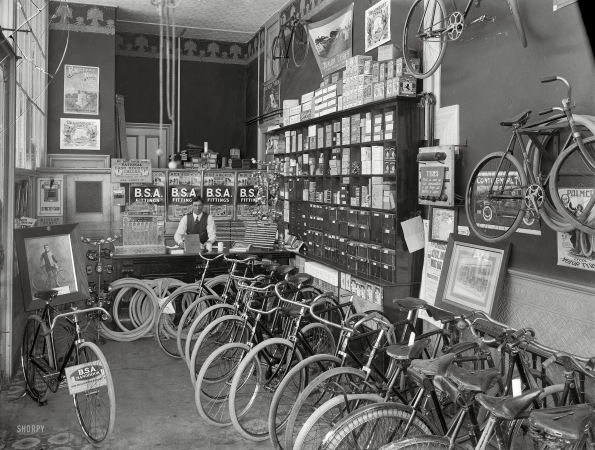 Photo showing: Tyres and Fittings -- 1910. Cycle shop interior. Christchurch, New Zealand.