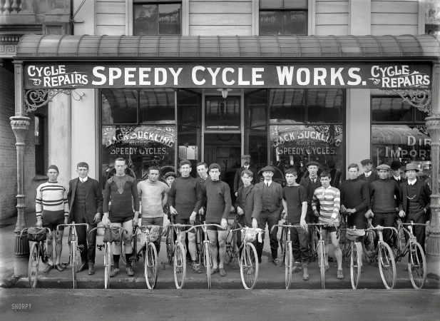 Photo showing: Speedy Cyclists -- Christchurch, New Zealand, circa 1913. Jack Suckling (center right with watch chain) and cyclists
outside Speedy Cycle Works, Manchester Street. Champion cyclist Phil O'Shea third from right.