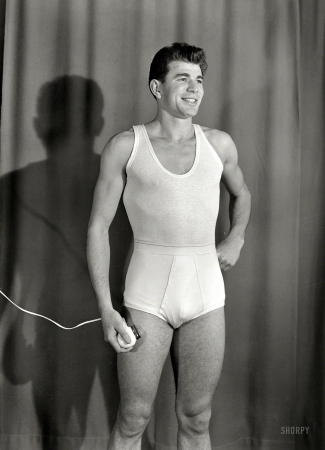Photo showing: A Close Shave -- New Zealand circa 1958. Men's underwear being modeled,