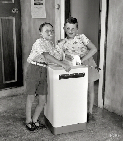 Photo showing: Tony and Paul -- Jan. 19, 1956. Wellington, New Zealand. Anthony and Paul Banks with a Hoover washing machine.